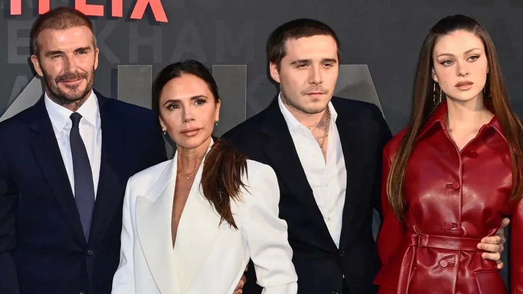 “David and Victoria Beckham pictured at a red‑carpet event, with subdued expressions hinting at underlying family tension amid reports of a feud involving son Brooklyn.”